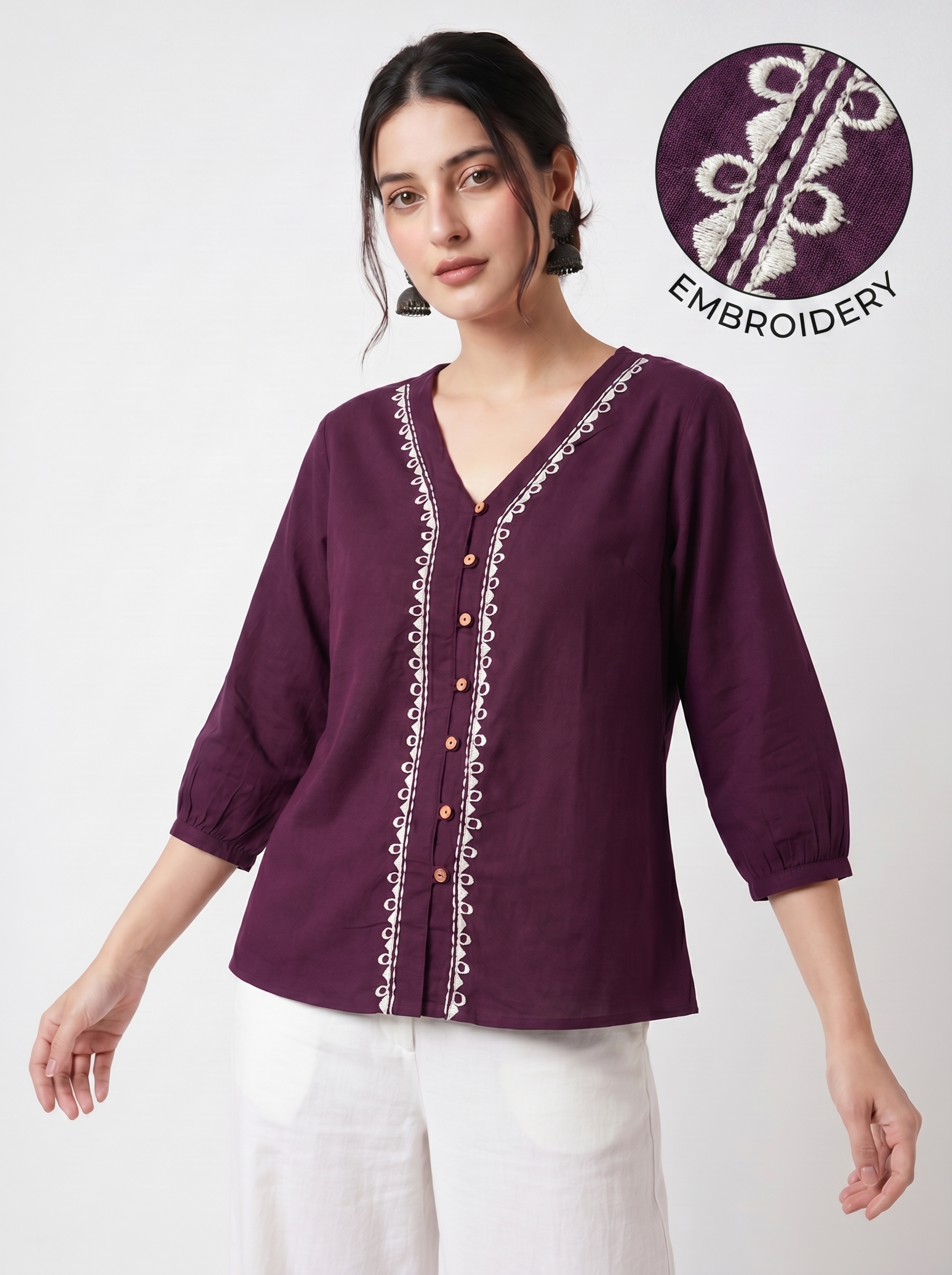 A rich plum purple top featuring elegant white contrast embroidery along the V-neckline and front placket for a refined statement look.
