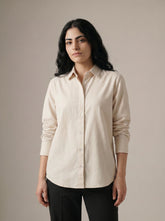 A timeless cream shirt top featuring a clean button-down front and classic collar for a refined, versatile look.
