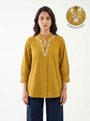A graceful mustard yellow tunic top featuring elegant off-white floral vine embroidery around the neckline for a refined handcrafted look.