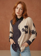 A contemporary beige and black shirt top featuring a striking asymmetric colorblock design with bold floral graphics for a distinctive modern look