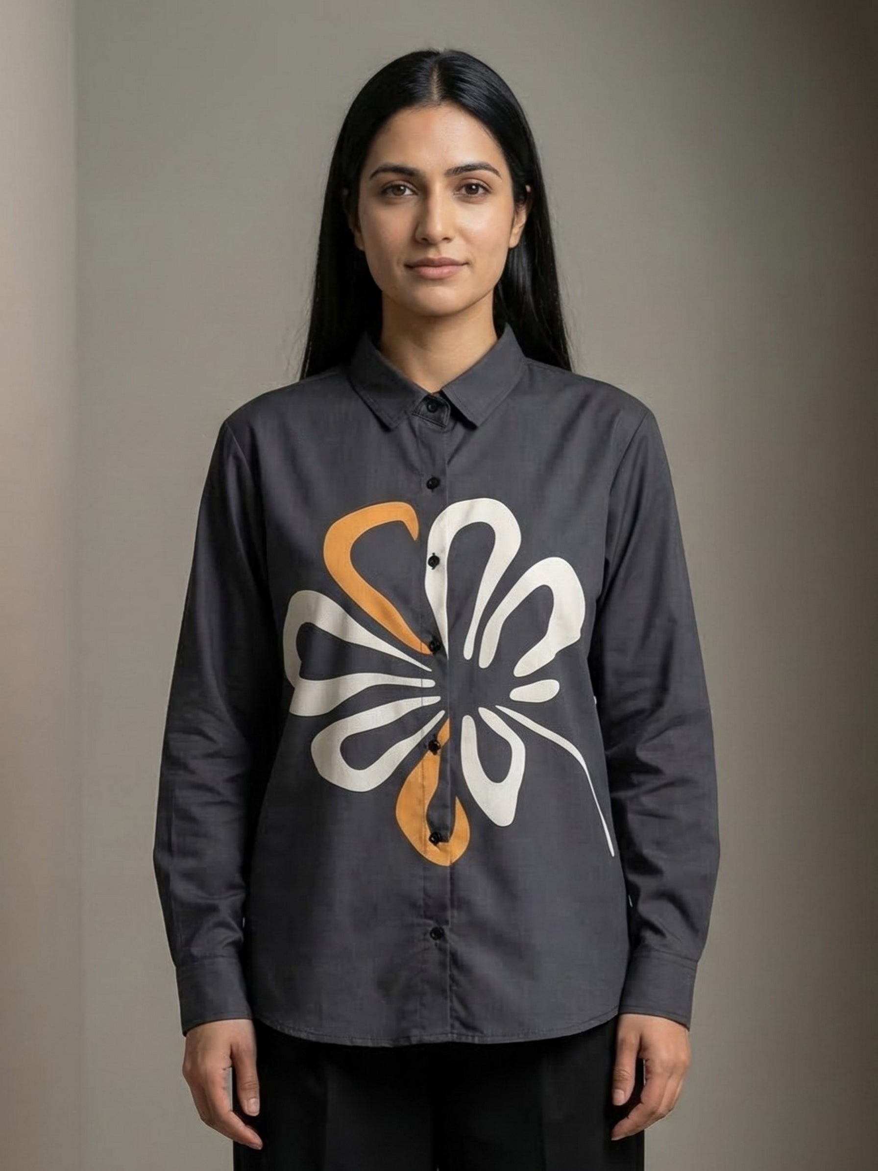 A contemporary charcoal grey shirt top featuring a bold white and mustard abstract floral graphic for a striking modern look.