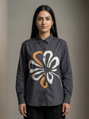 A contemporary charcoal grey shirt top featuring a bold white and mustard abstract floral graphic for a striking modern look.