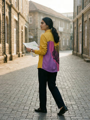 A striking mustard yellow shirt top featuring a bold contrast pink-purple panel at the back with an oversized black floral graphic for a statement finish.