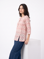 A stylish off-white top featuring soft pink ethnic-inspired motifs for a fresh everyday look
