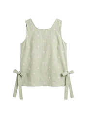 A sleeveless light sage green top with a subtle white floral pattern and side tie bows, displayed flat against a white background.