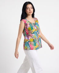 A vibrant teal sleeveless top featuring playful pink, yellow, green, and blue botanical motifs for a fresh statement look.