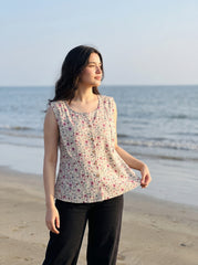 A charming Beige sleeveless top featuring delicate pink mini florals with subtle grey and green botanical accents for a soft feminine look.