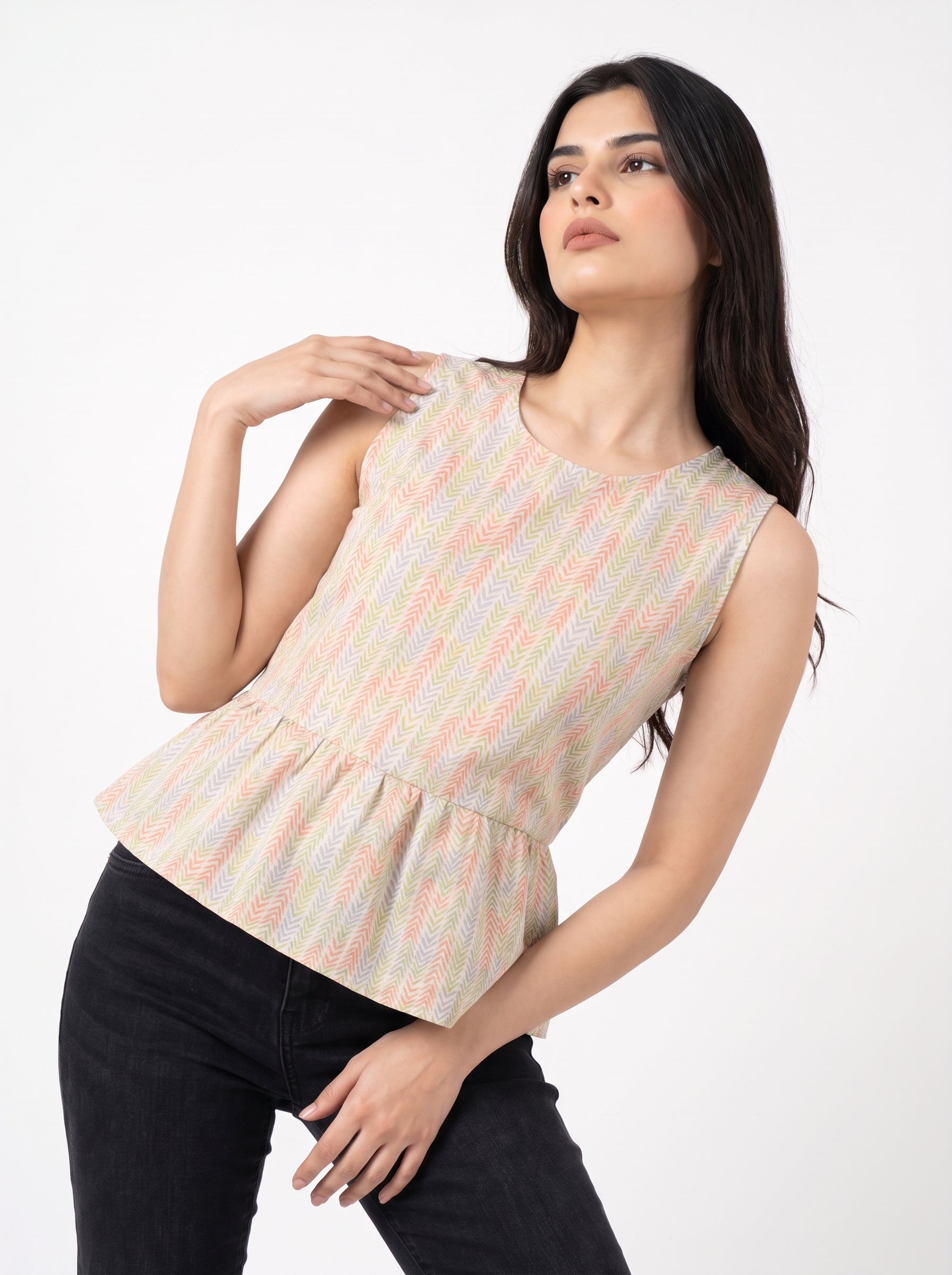 A fresh off-white sleeveless top featuring a soft pastel chevron print in peach, green, lavender, and yellow tones