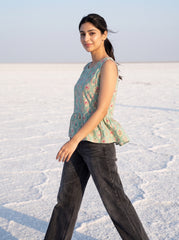 A stylish mint green sleeveless top featuring an elegant ethnic-inspired teardrop motif print all over.