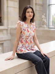 A fresh off-white top featuring rich rust, orange, and burgundy floral motifs for a warm feminine look.