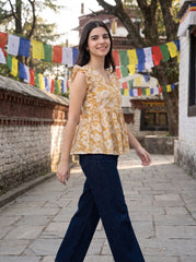 A cheerful mustard yellow top featuring elegant white floral motifs for a bright and feminine look.