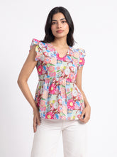 A lively off-white top featuring bright pink, blue, green, peach, and yellow floral motifs for a cheerful statement look. The V-neckline and layered ruffle sleeves add a playful feminine touch, while the gathered peplum waist creates a flattering, flowy silhouette.