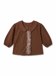 A brown short-sleeve blouse with a Peter Pan collar and white floral embroidery down the center front, displayed flat against a white background.