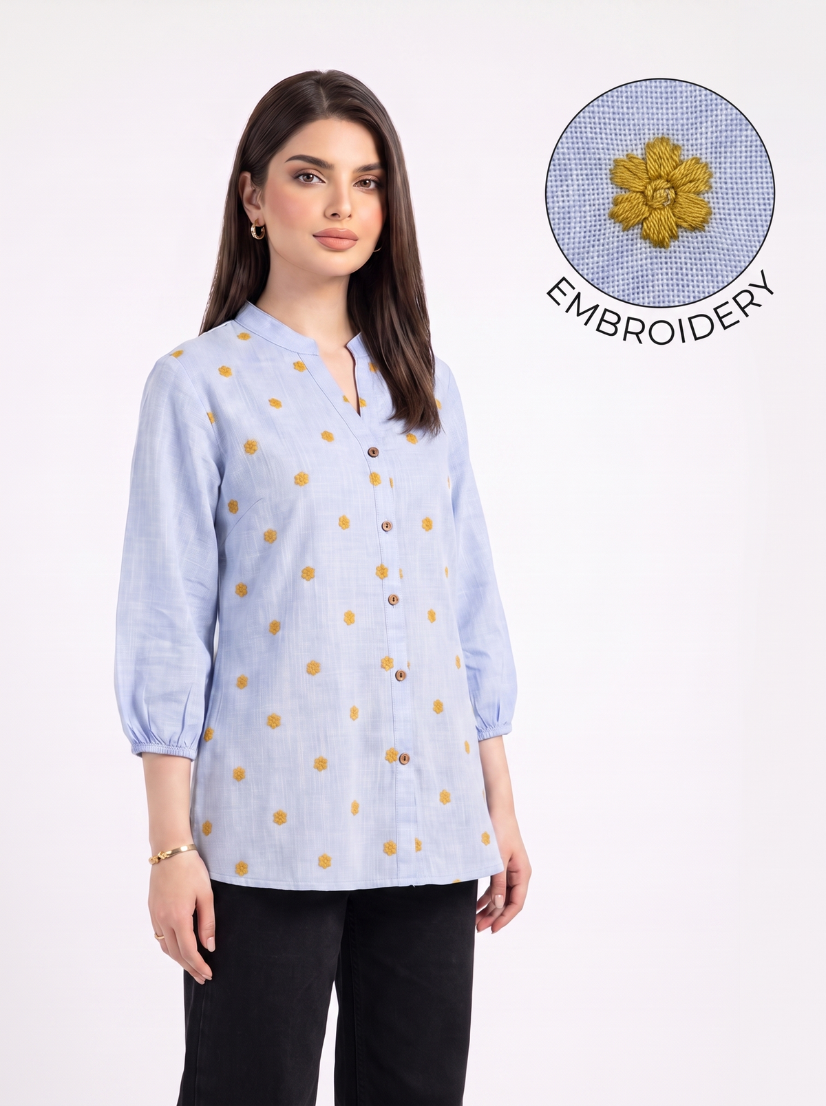 itna nahi 4 line jitna A fresh sky blue top featuring delicate mustard floral embroidery for a subtle contrast. The split neckline, front button detailing, and 3/4 gathered sleeves give it a polished yet easy look.