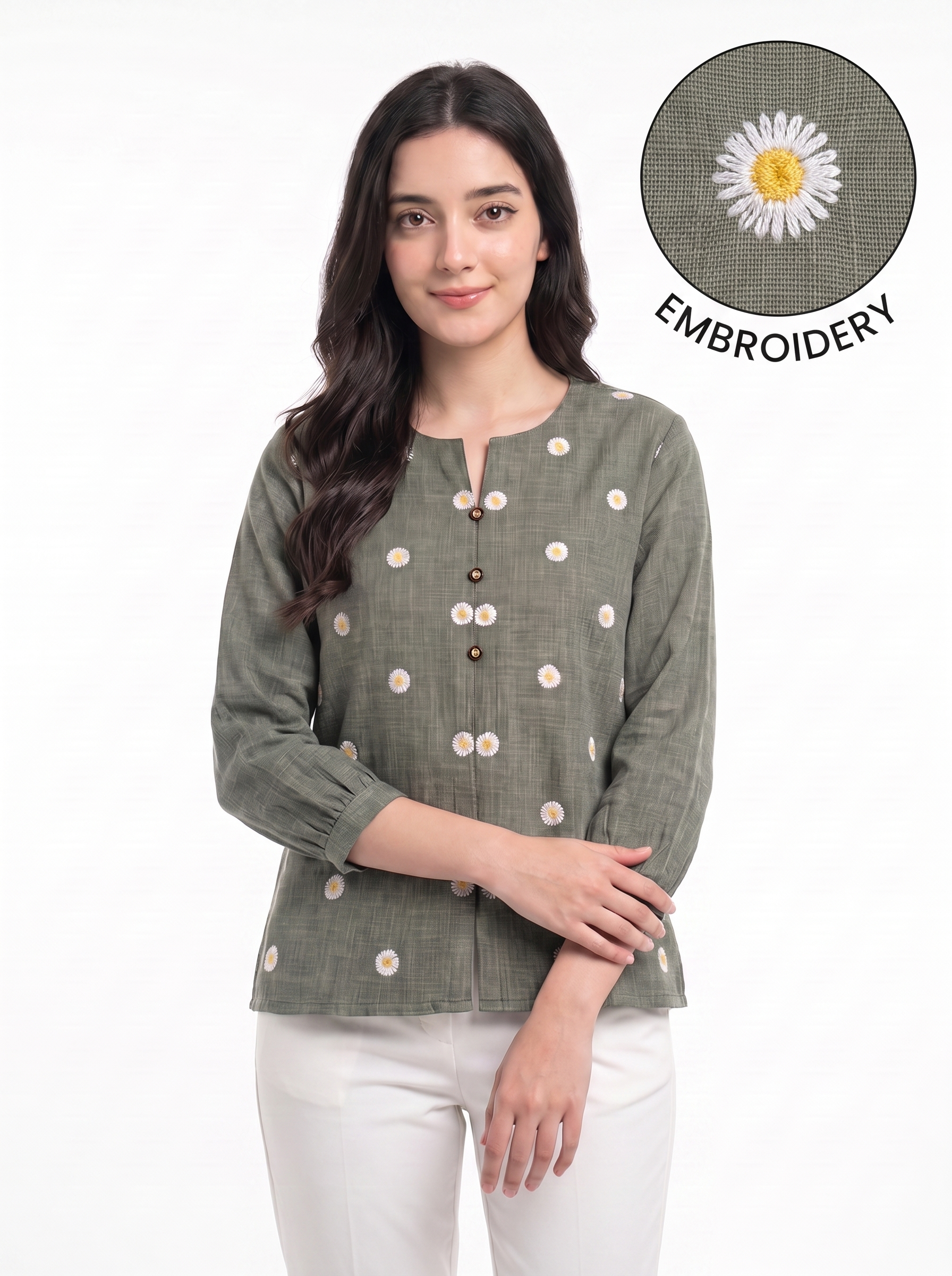 A woman wearing a sage green linen top with white and yellow daisy embroidery, paired with white pants. An inset circle in the top right shows a close-up of the embroidery detail with the text 'EMBROIDERY'.