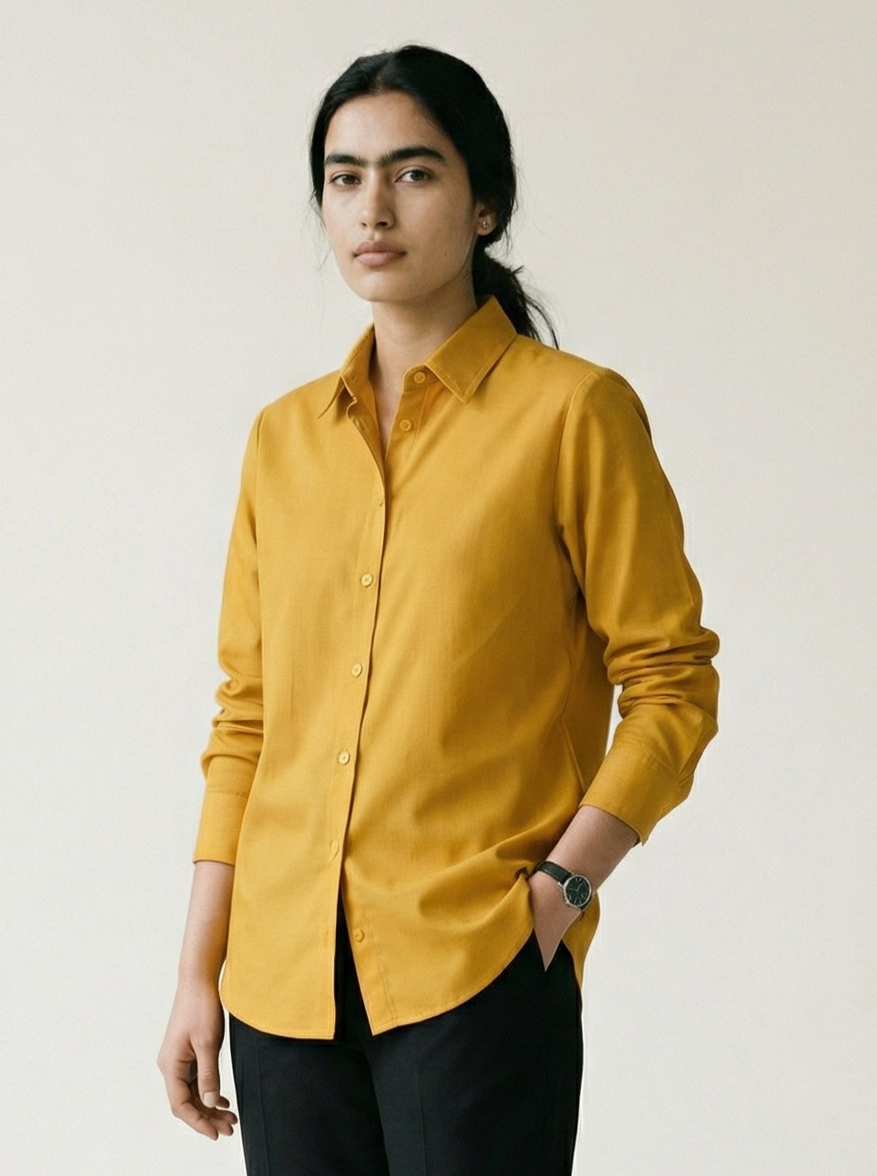 A striking mustard yellow shirt top featuring a bold contrast pink-purple panel at the back with an oversized black floral graphic for a statement finish.