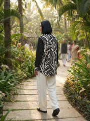 A contemporary beige and black shirt top featuring a striking asymmetric colorblock design with bold floral graphics for a distinctive modern look.