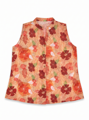 A sleeveless button-front vest with a vibrant floral print on a peach and orange base, featuring dark red hibiscus flowers and green leaves.