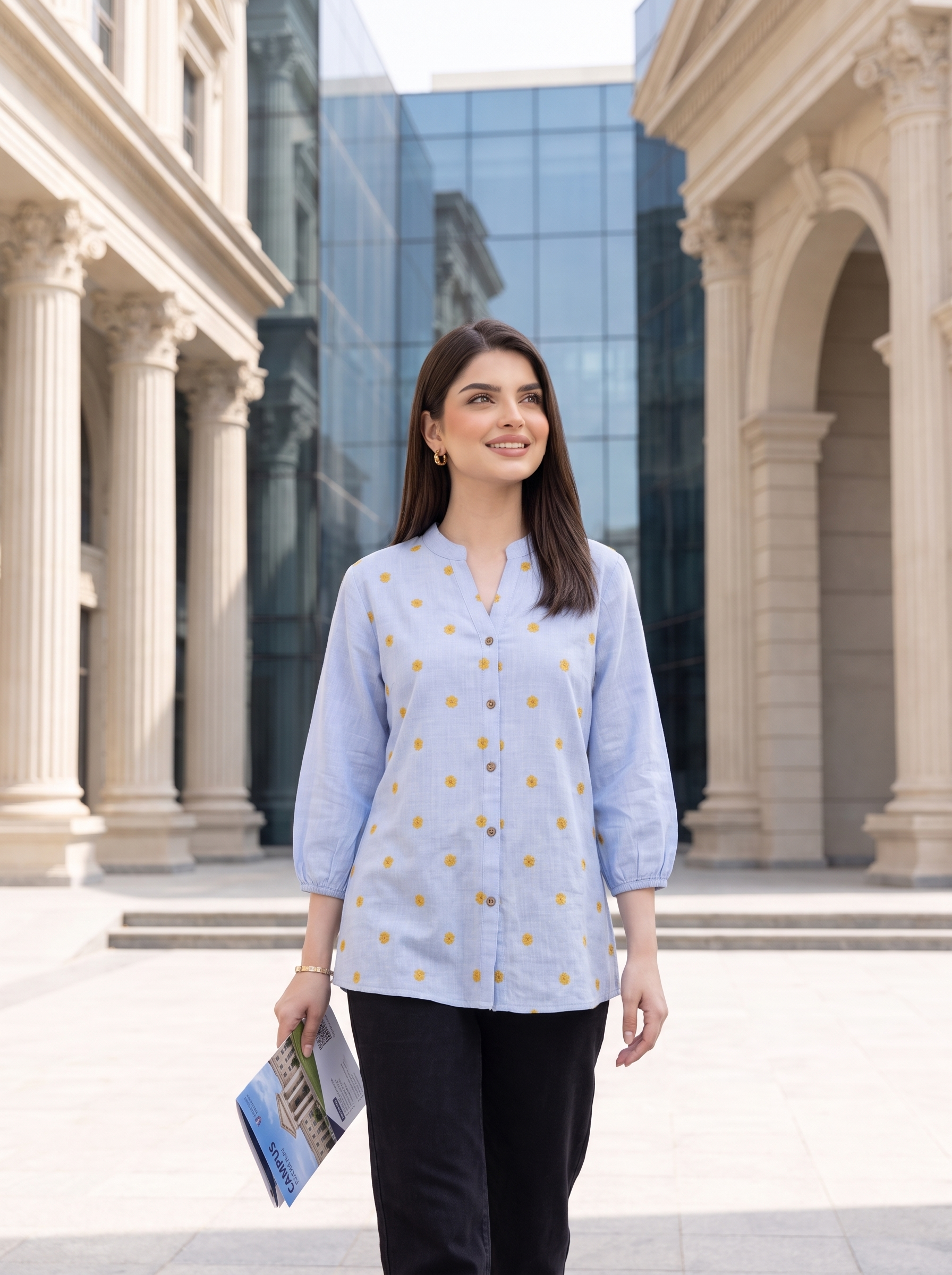 A fresh sky blue top featuring delicate mustard floral embroidery for a subtle contrast. The split neckline, front button detailing, and 3/4 gathered sleeves give it a polished yet easy look.