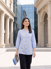 A fresh sky blue top featuring delicate mustard floral embroidery for a subtle contrast. The split neckline, front button detailing, and 3/4 gathered sleeves give it a polished yet easy look.
