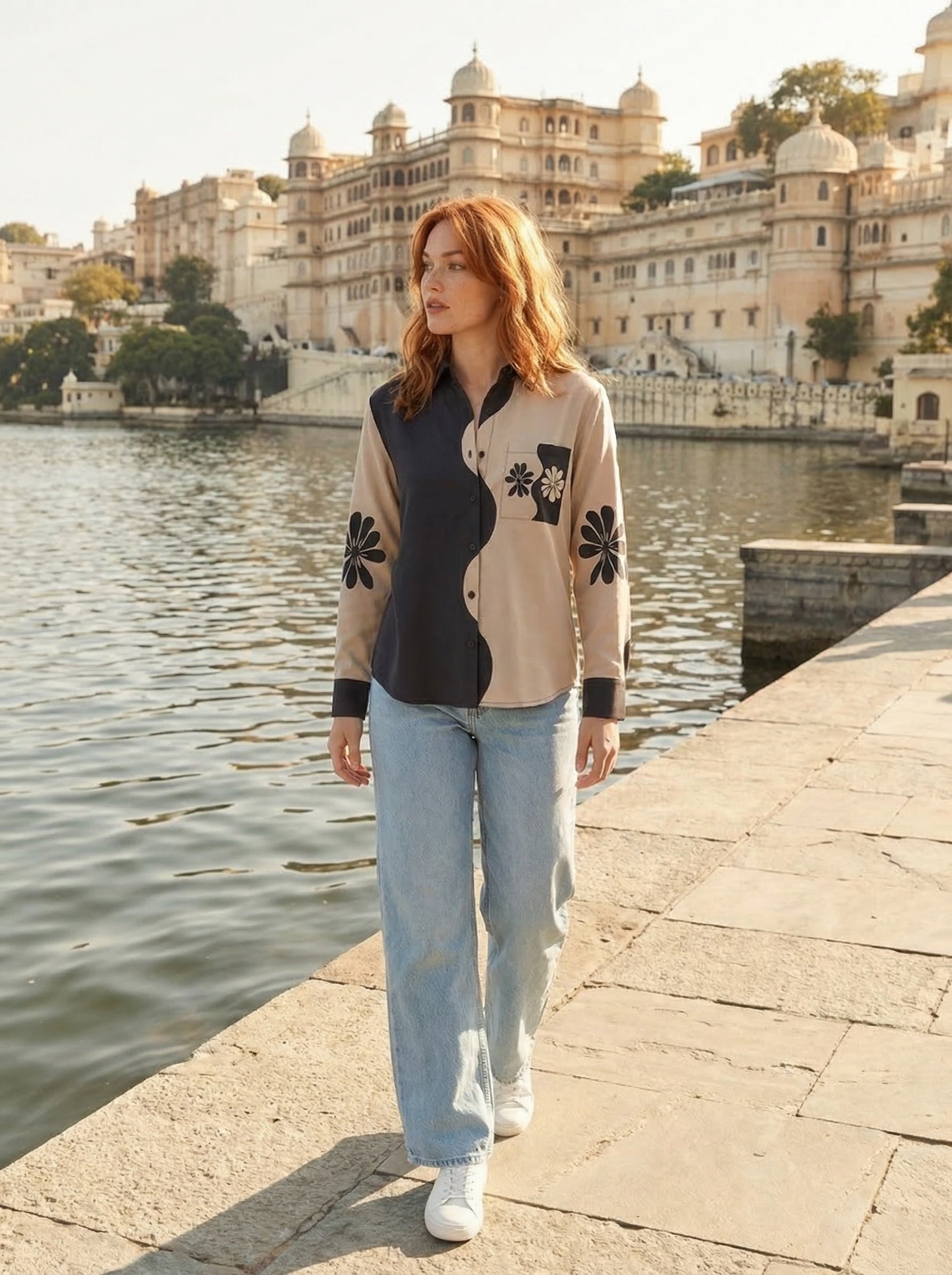 A contemporary beige and black shirt top featuring a striking asymmetric colorblock design with bold floral graphics for a distinctive modern look