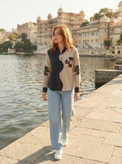 A contemporary beige and black shirt top featuring a striking asymmetric colorblock design with bold floral graphics for a distinctive modern look