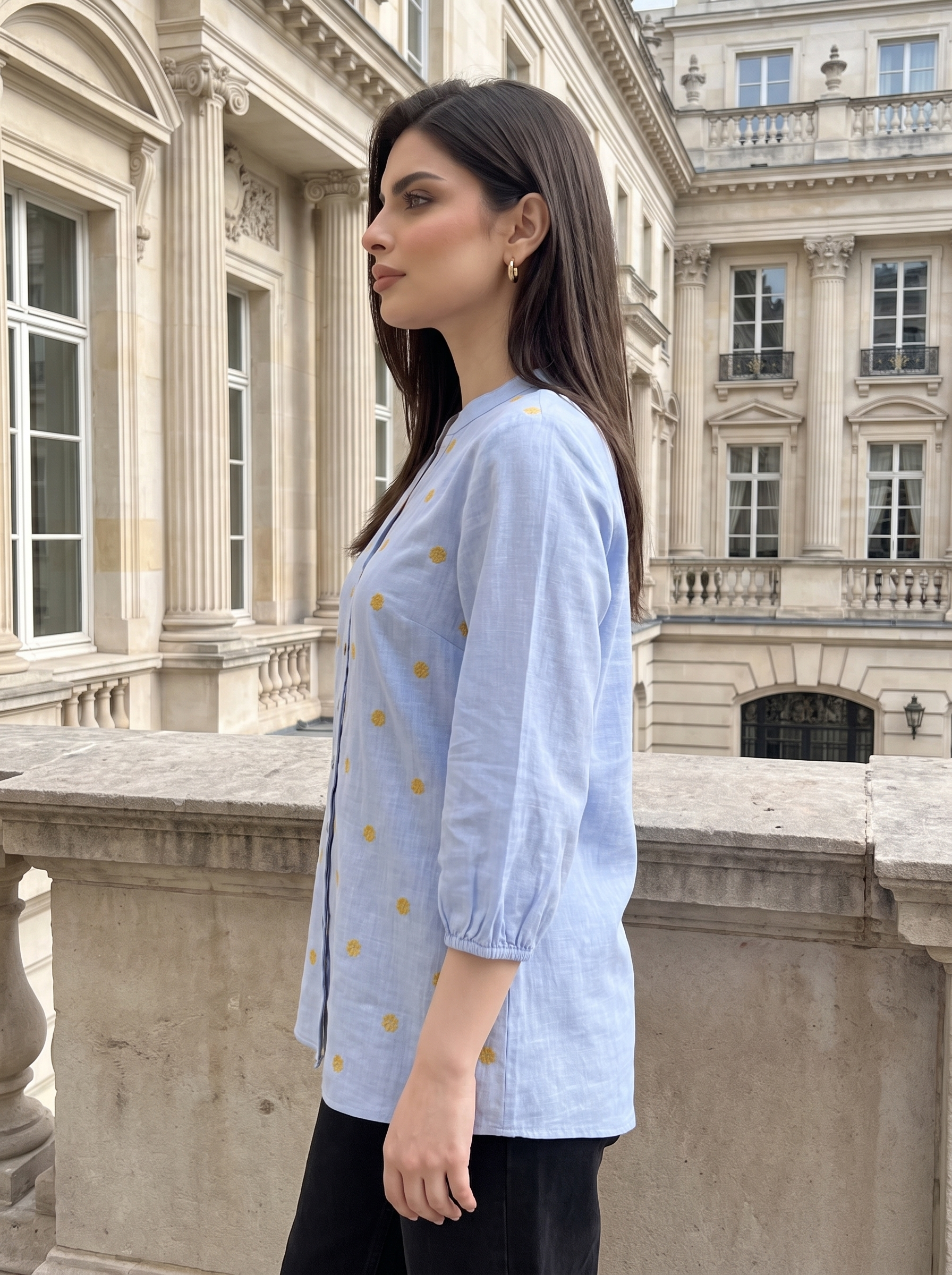 A fresh sky blue top featuring delicate mustard floral embroidery for a subtle contrast. The split neckline, front button detailing, and 3/4 gathered sleeves give it a polished yet easy look.