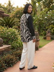 A contemporary beige and black shirt top featuring a striking asymmetric colorblock design with bold floral graphics for a distinctive modern look.
