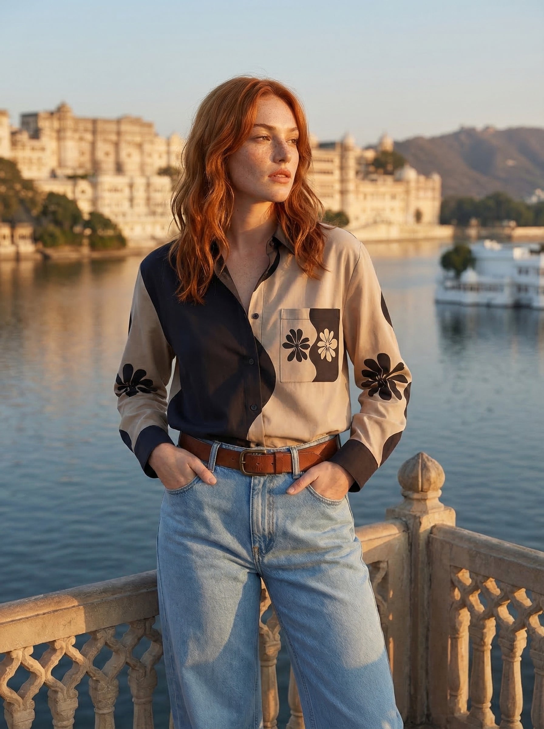 A contemporary beige and black shirt top featuring a striking asymmetric colorblock design with bold floral graphics for a distinctive modern look