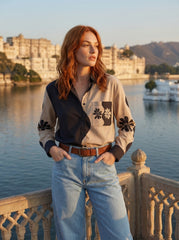 A contemporary beige and black shirt top featuring a striking asymmetric colorblock design with bold floral graphics for a distinctive modern look