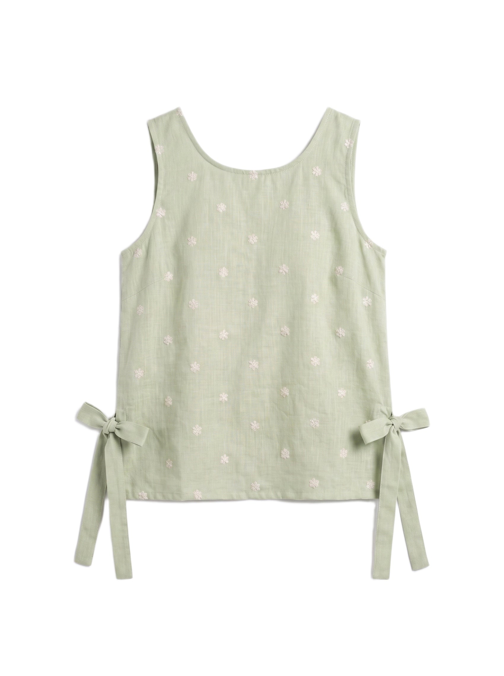A sleeveless light sage green top with a subtle white floral pattern and side tie bows, displayed flat against a white background.