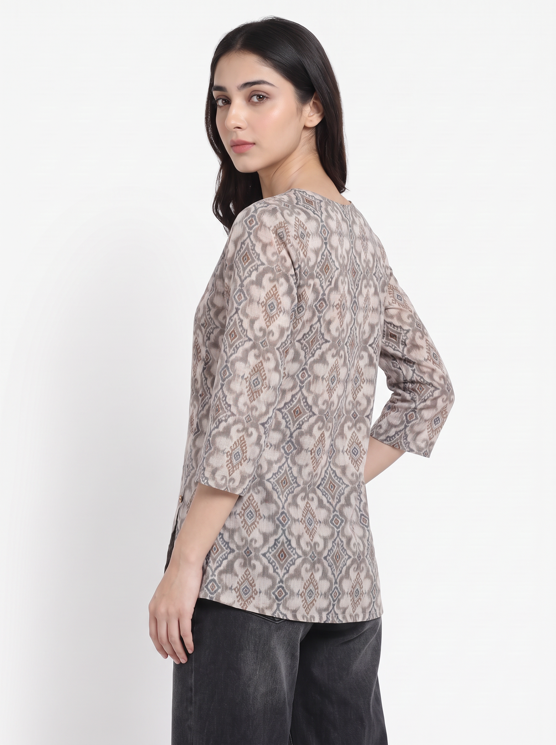 A woman wearing a three-quarter sleeve top with a beige and gray snake-print pattern, shown from a side-back angle against a plain white background.