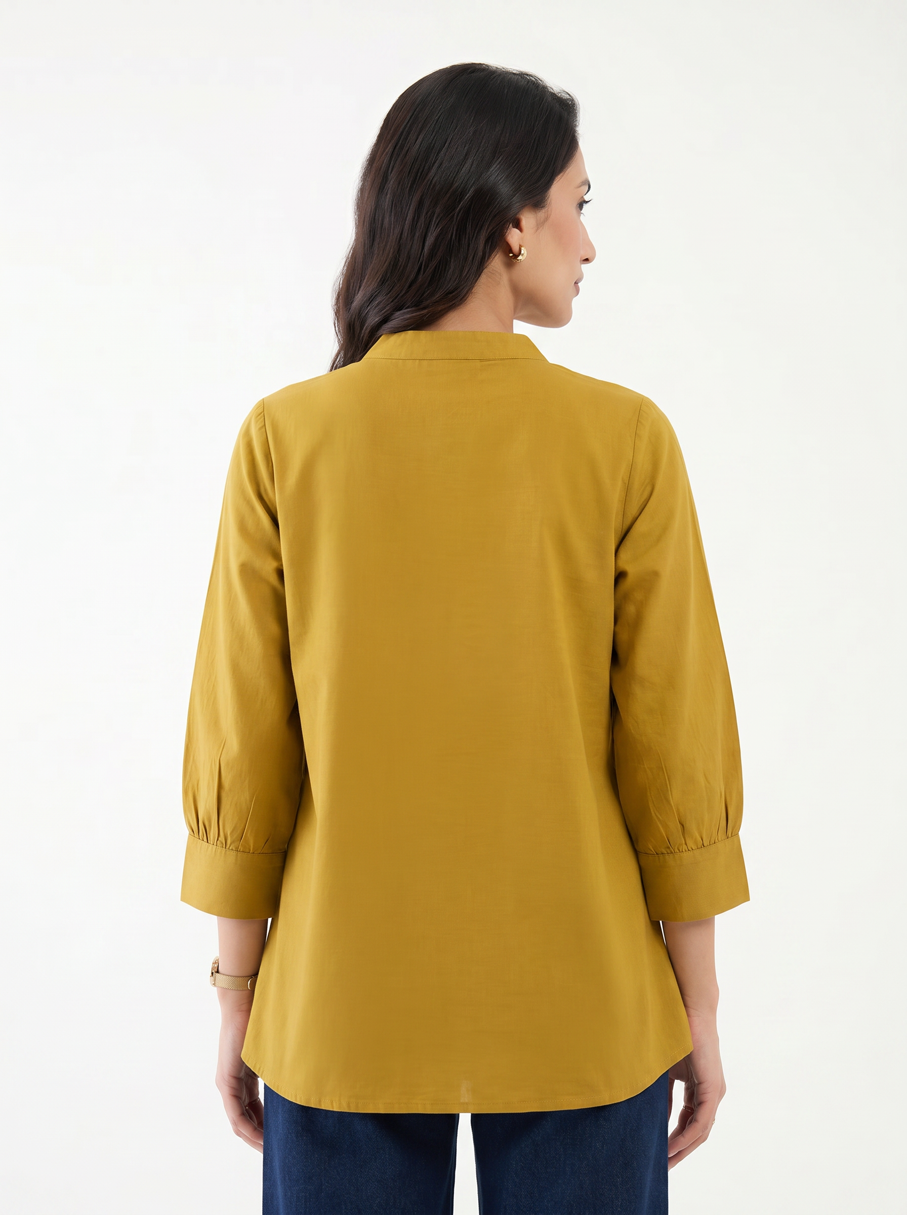 A graceful mustard yellow tunic top featuring elegant off-white floral vine embroidery around the neckline for a refined handcrafted look.