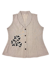 A sleeveless beige linen vest with a shawl collar, black buttons, and black floral embroidery on the front, displayed against a white background.