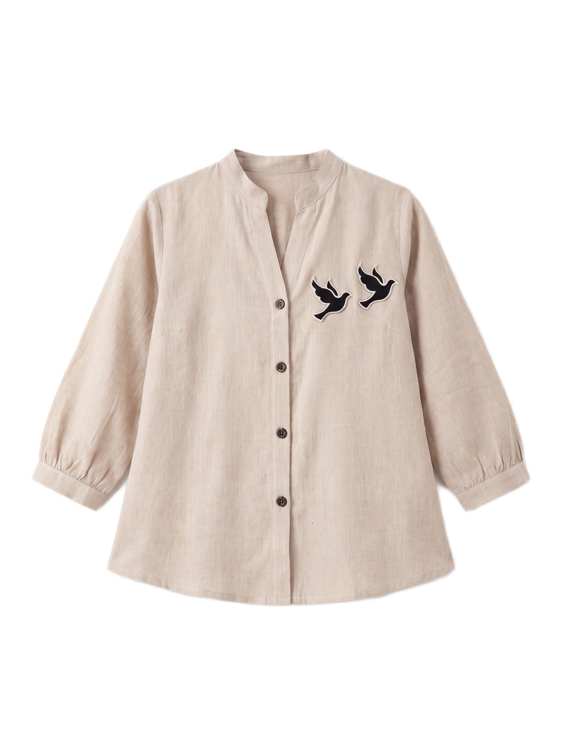 A beige long-sleeve linen button-up shirt with a stand collar and embroidered flying birds on the left chest, displayed on a clean white background.