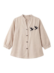 A beige long-sleeve linen button-up shirt with a stand collar and embroidered flying birds on the left chest, displayed on a clean white background.