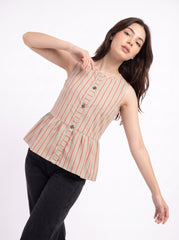A woman modeling a sleeveless, peplum-style top with vertical red and beige stripes on a white background, paired with black pants.