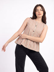 A woman modeling a sleeveless button-front top with vertical peach and beige stripes on a white background, paired with black pants.