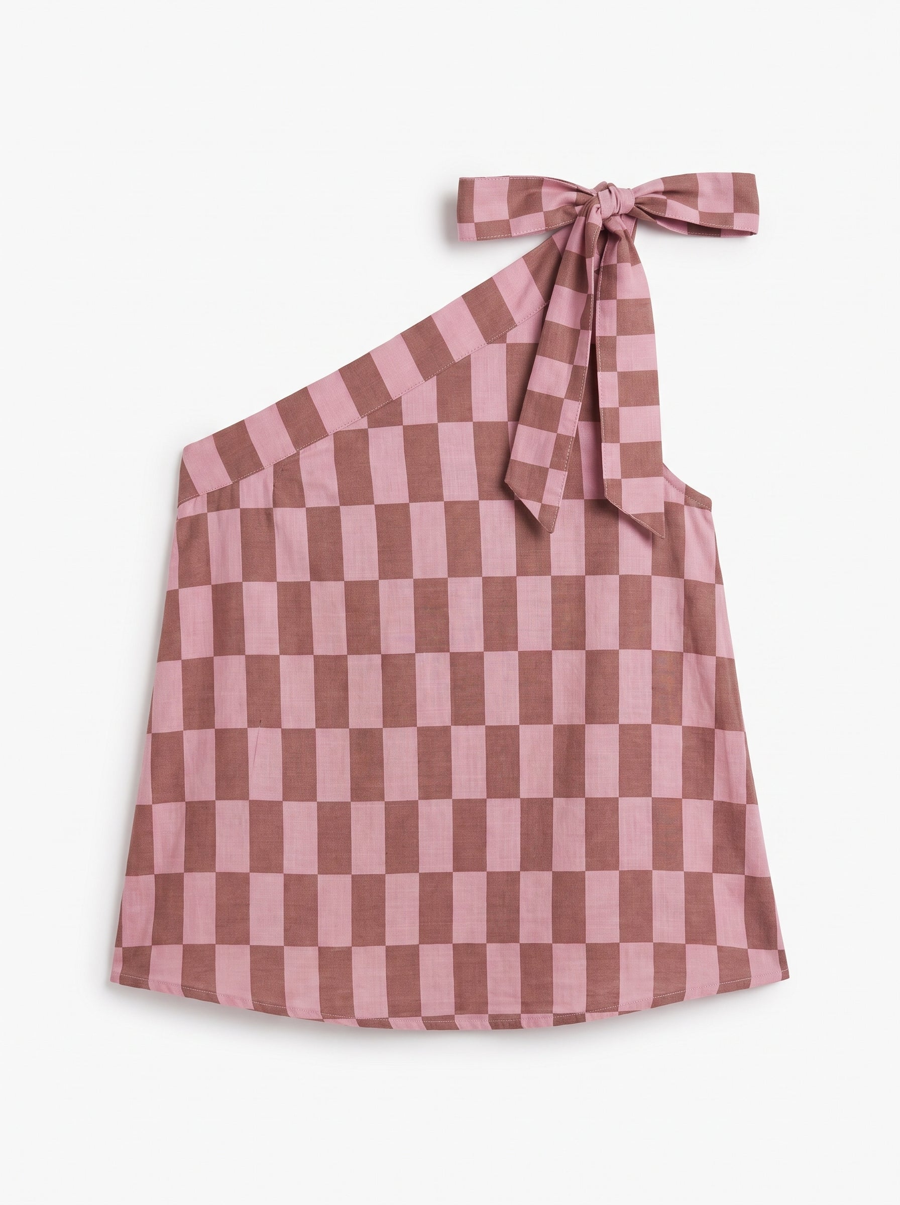 A pink and brown checkerboard one-shoulder top with a tie-neck bow, displayed flat against a light off-white background.