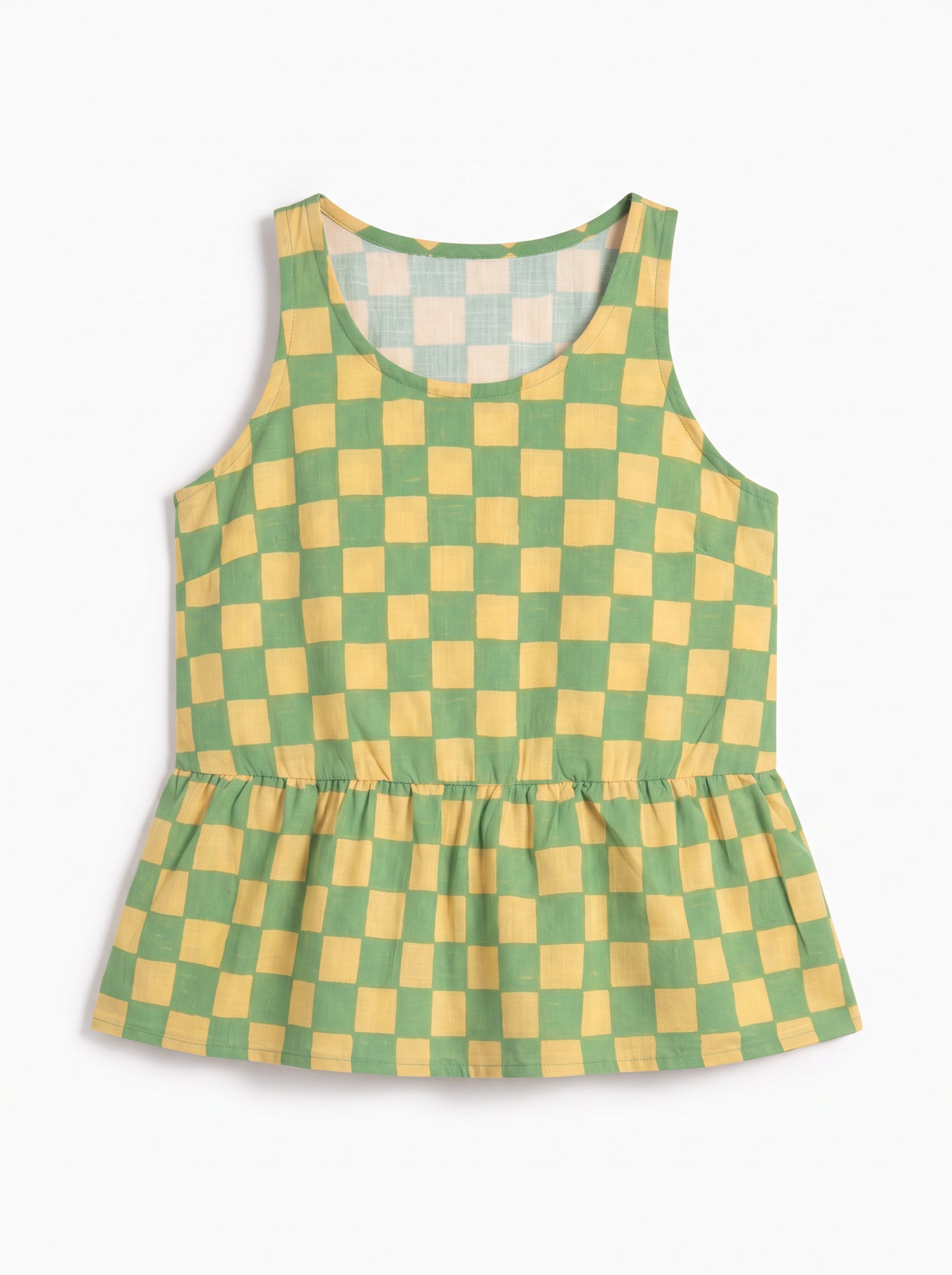 A sleeveless children's top with a green and yellow checkered pattern and a gathered peplum hem, displayed on a clean white background.