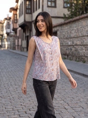 A soft lavender sleeveless top featuring delicate pink and blue mini florals for a fresh feminine look.
