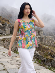 A vibrant teal sleeveless top featuring playful pink, yellow, green, and blue botanical motifs for a fresh statement look.