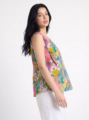 A vibrant teal sleeveless top featuring playful pink, yellow, green, and blue botanical motifs for a fresh statement look.