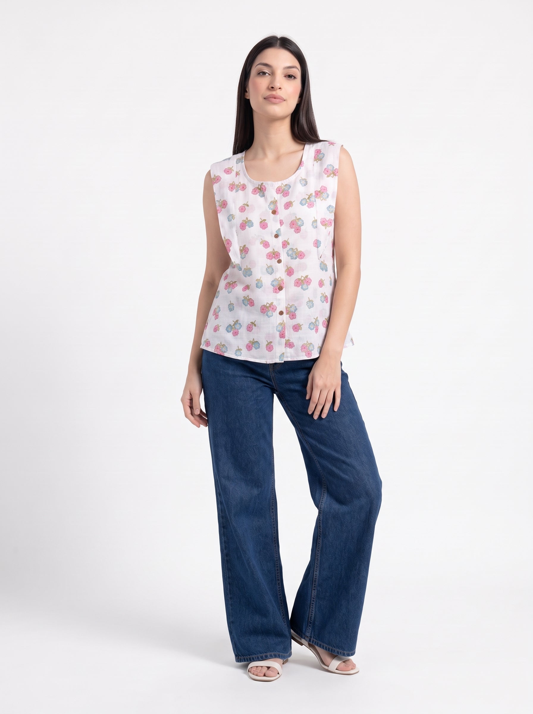 A fresh off-white sleeveless top featuring delicate pink and blue floral clusters for a soft feminine look. 