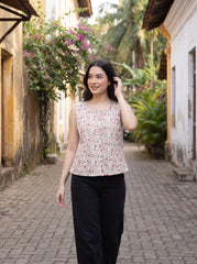 A charming Beige sleeveless top featuring delicate pink mini florals with subtle grey and green botanical accents for a soft feminine look. 