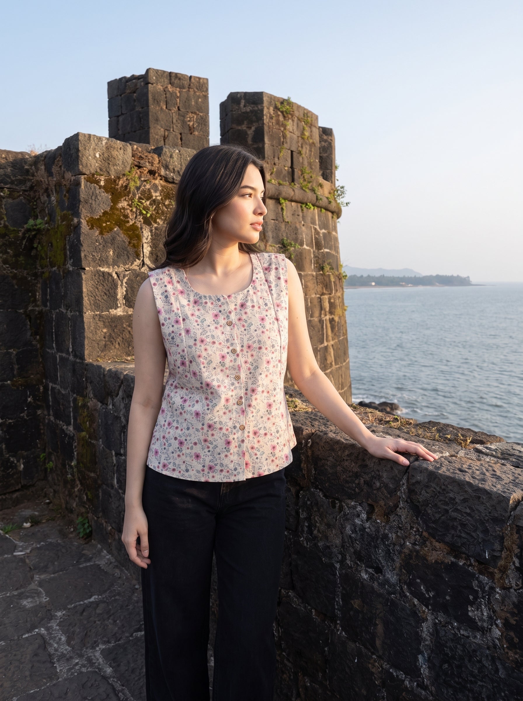 A charming Beige sleeveless top featuring delicate pink mini florals with subtle grey and green botanical accents for a soft feminine look.   