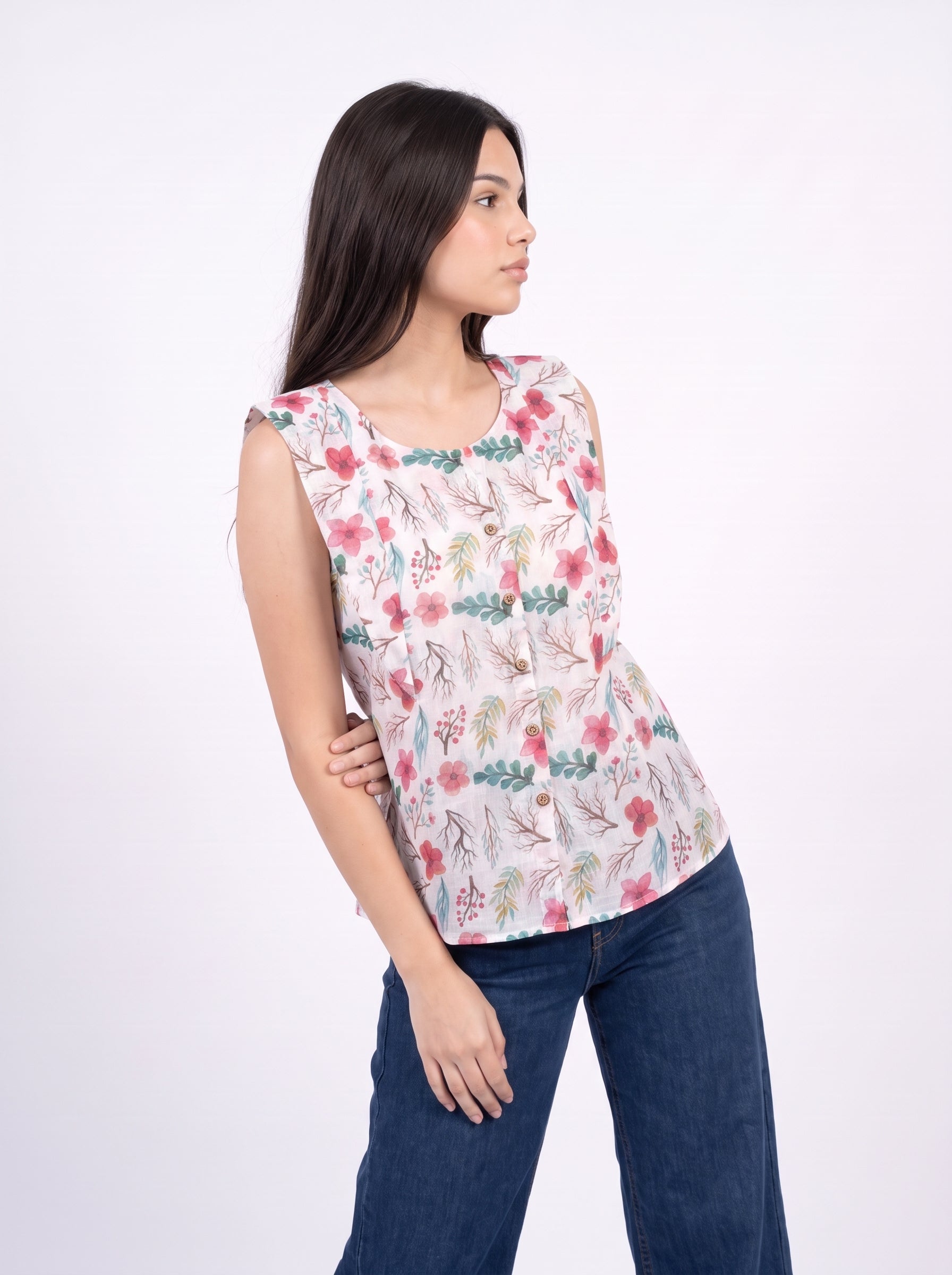 A fresh off-white sleeveless top featuring coral pink florals with teal-green leaves and delicate botanical branches for a charming everyday look.
