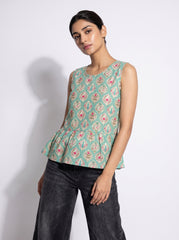A stylish mint green sleeveless top featuring an elegant ethnic-inspired teardrop motif print all over. 