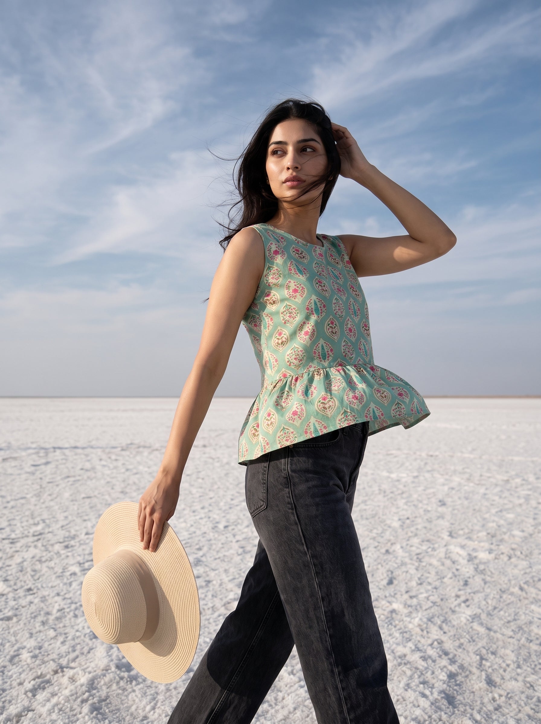 A stylish mint green sleeveless top featuring an elegant ethnic-inspired teardrop motif print all over. 
