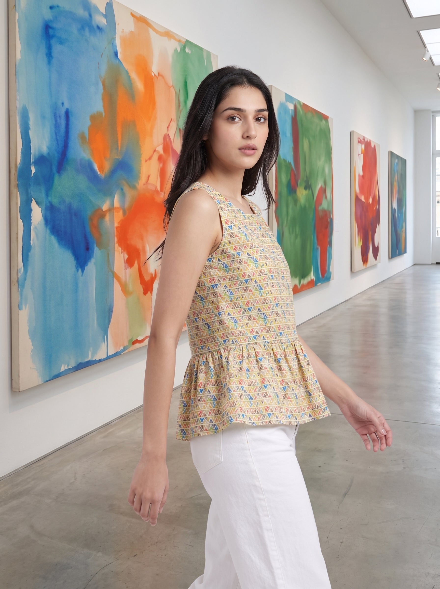 A fresh Multicolor sleeveless top featuring colorful geometric triangle motifs in blue, red, green, and orange tones. 